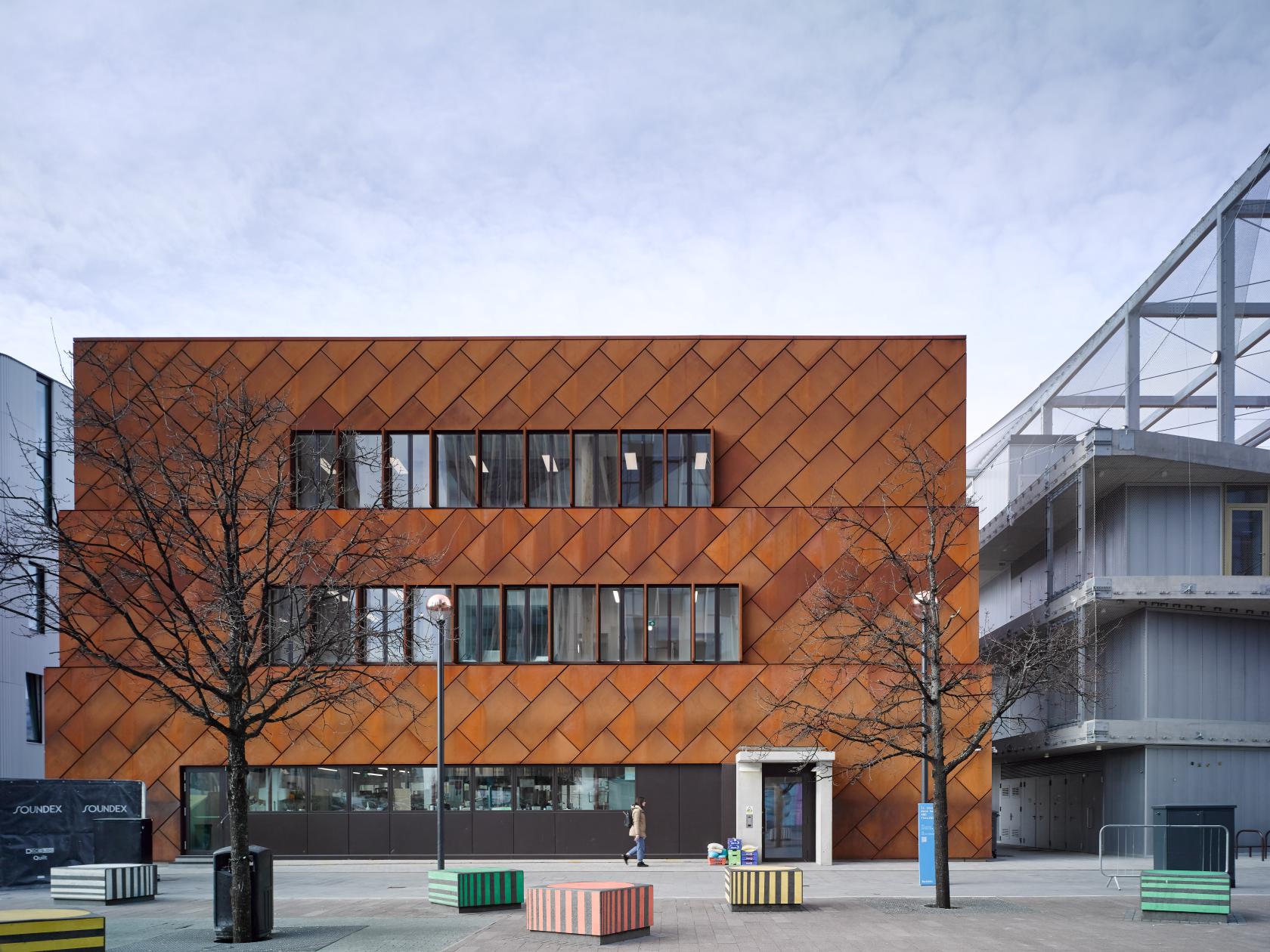 A versatile event space with a copper-toned geometric facade and large windows at Clod Ensemble Skylight Studio.