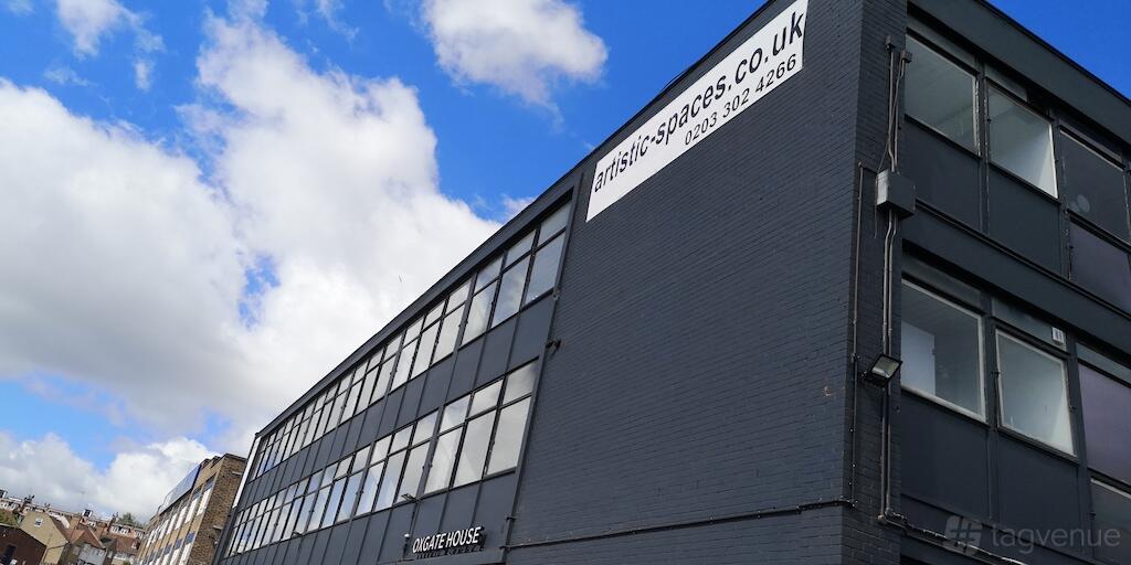 A film and photo studio with a dark brick facade and large industrial-style windows at Shots4u.