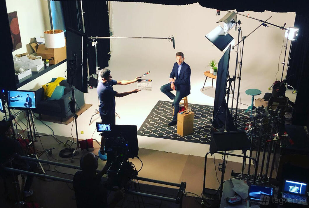 A photo and film studio with lighting rigs, video cameras, and a seamless white backdrop at Maximize.