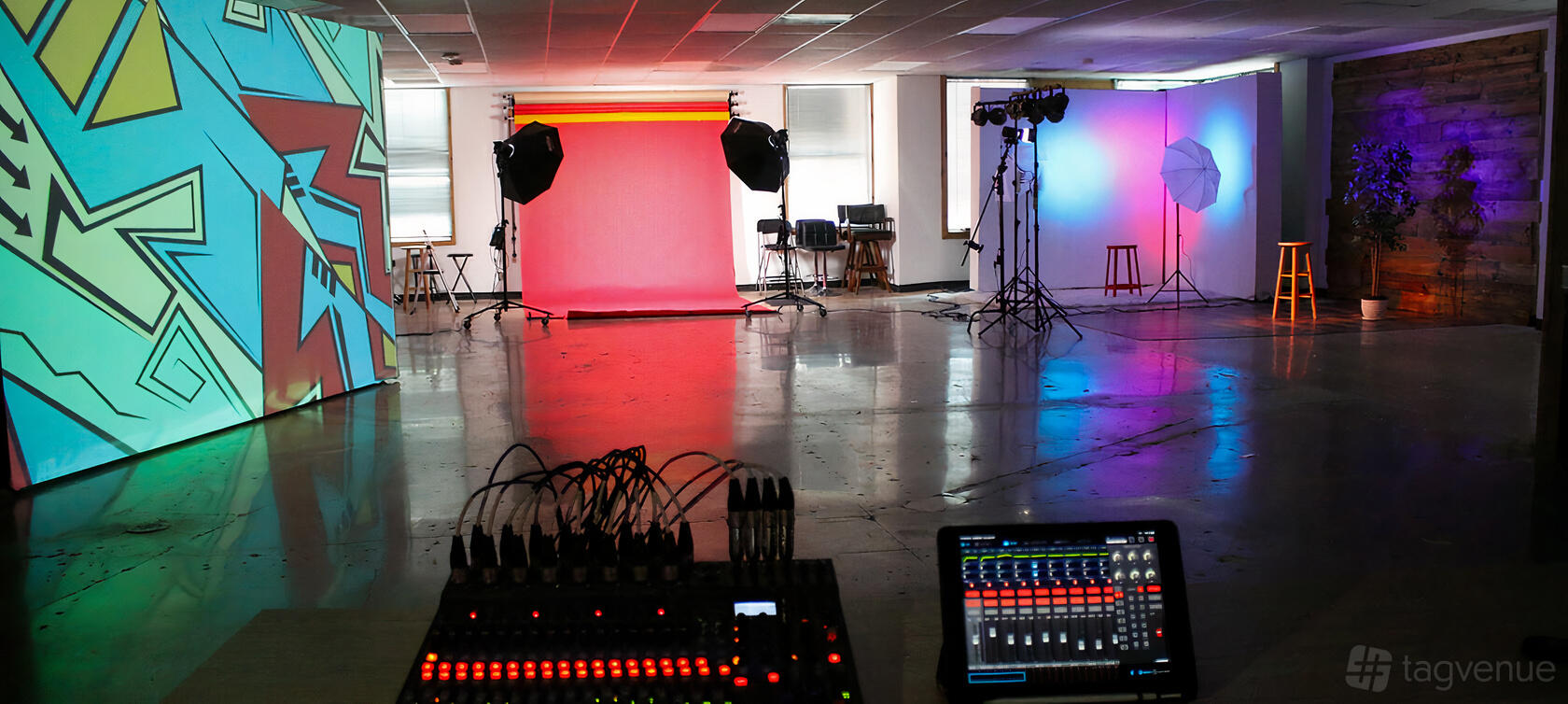 A photo studio with colorful backdrops, professional lighting, and a sound mixer at The Creatives Factory.