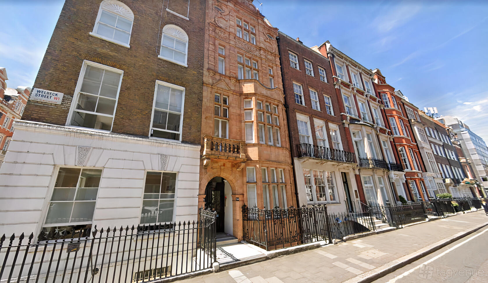 A conference centre with an ornate stone entrance and historic red brick facade at 54 Welbeck St W1G 9XS
