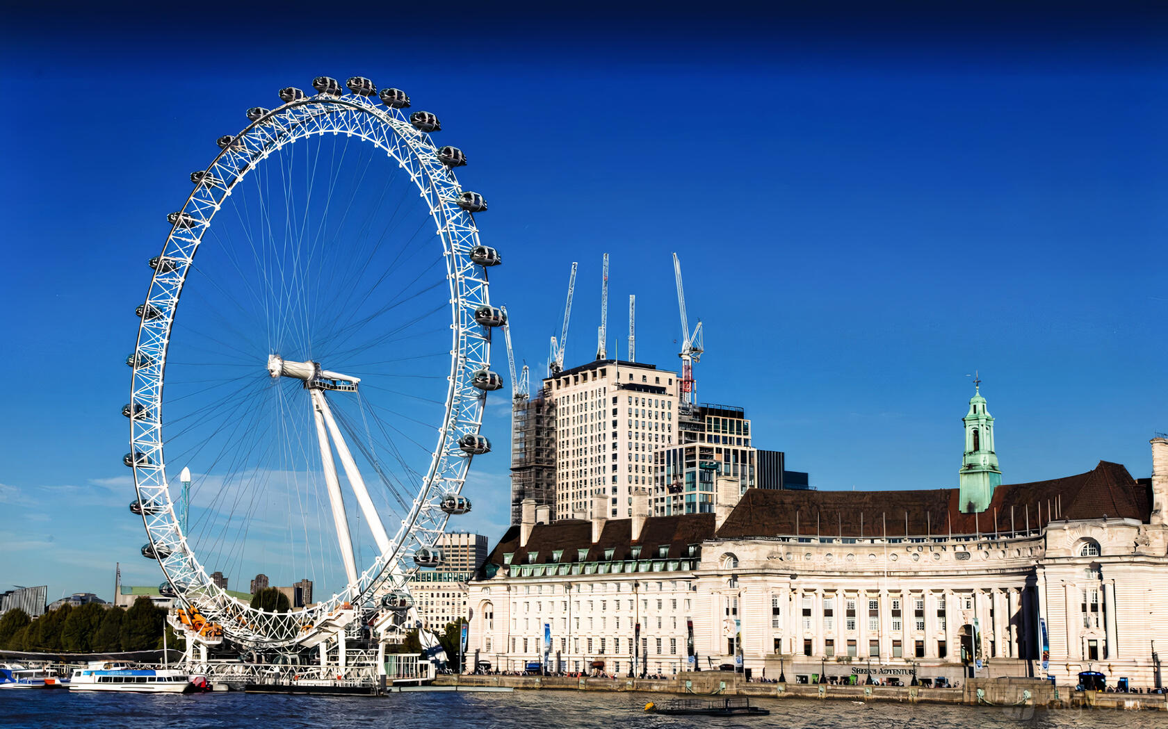 A versatile event space with the London Eye observation wheel next to a riverside historic building at London Eye.