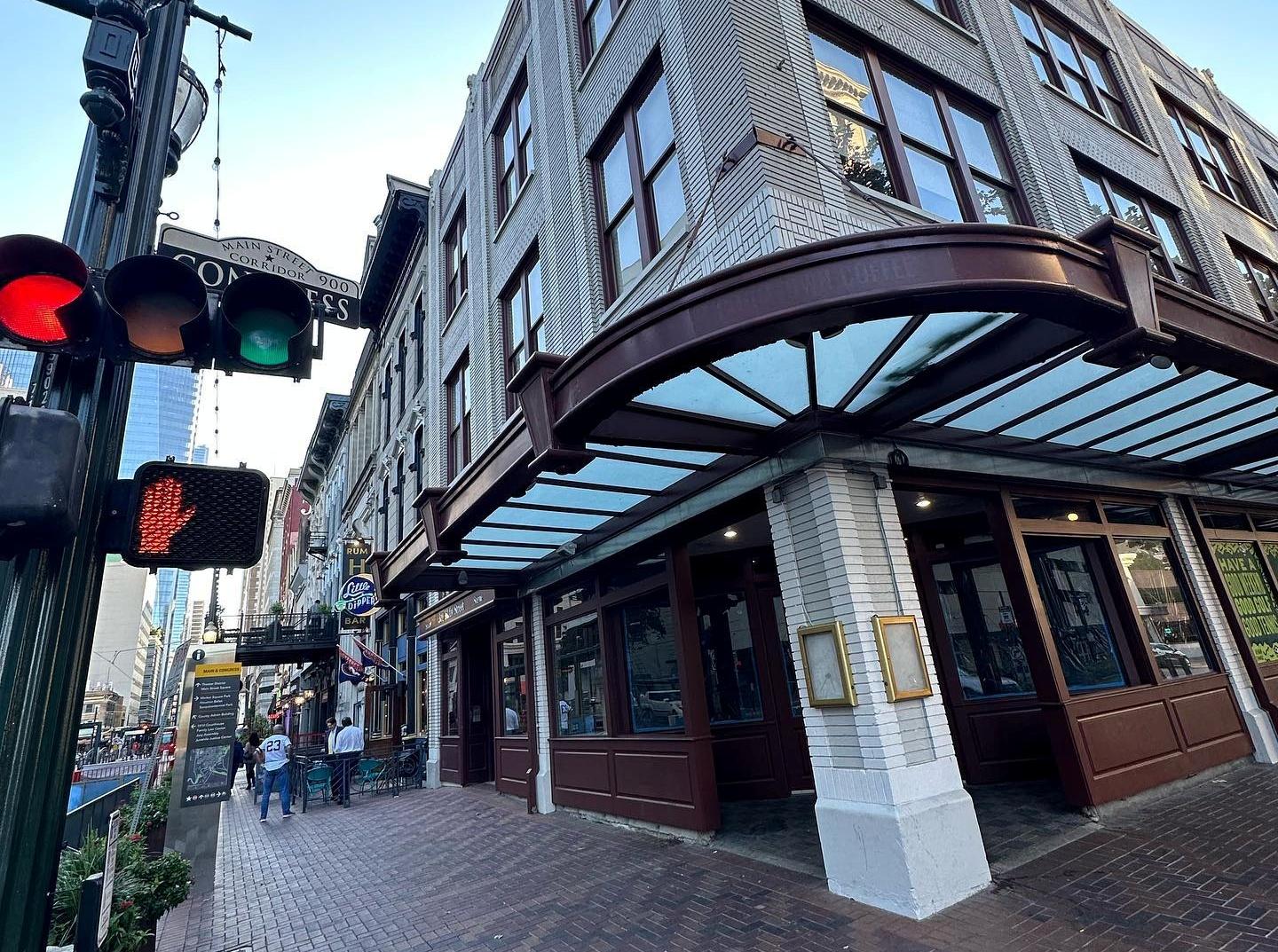 A corner nightclub with brick exterior, large windows, and a glass awning at La Diabla Retro Bar.