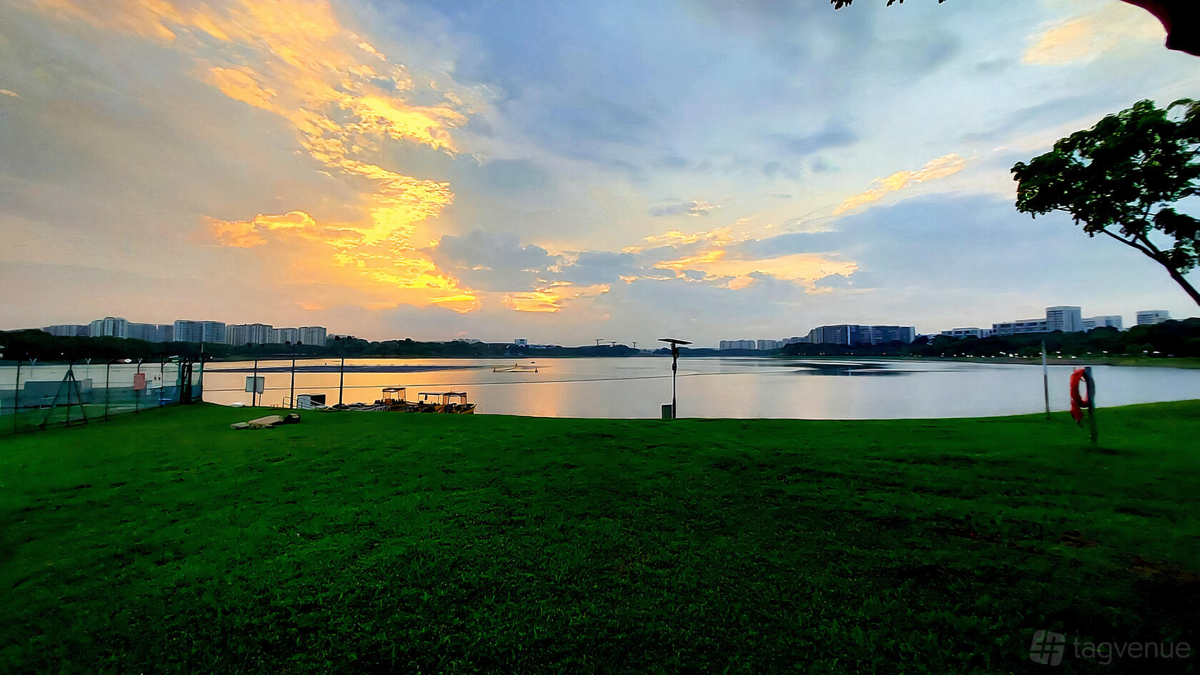 A restaurant terrace with open grassy lawn and waterfront views at Georges @ Waterfront (Bedok).
